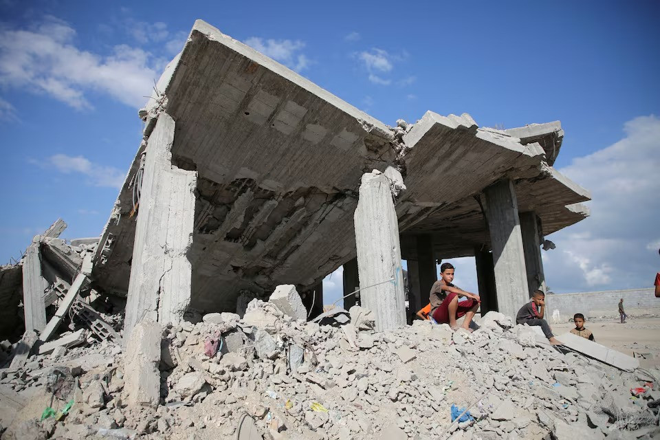 palestinian boys sit on piles of debris at the site of israeli strikes on houses amid the israel hamas conflict in khan younis in southern gaza on october 2 2024 photo reuters