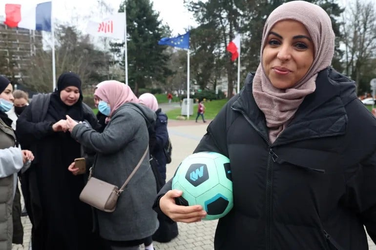 writer majid siham poses with a football during a gathering to support the women s football team les hijabeuses in front of the city hall in lille as part of a protest against the controversial hijab ban in competitive sports in france photo reuters