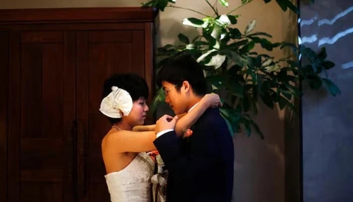 a couple prepares to participate in a staged mass wedding organised as part of a matchmaking event to inspire singles to get married in a suburban area of shanghai china on may 18 2013 photo reuters