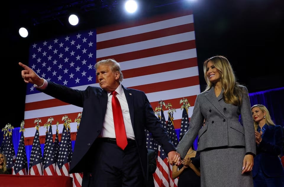 donald trump gestures as he holds hands with his wife melania during his rally in west palm beach florida photo reuters