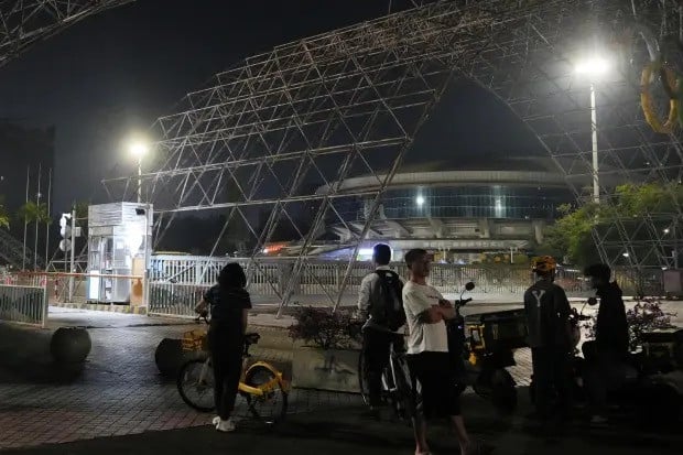 people gather near a sports center after a man rammed a car into people exercising at the center in zhuhai china on november 11 2024 photo ap