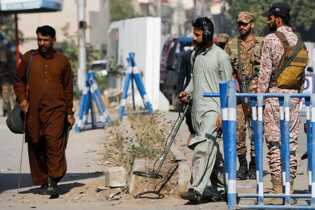 members of the bomb disposal squad in plain clothes survey the area after yesterday s attack on a police station in karachi pakistan on february 18 2023 photo reuters members of the bomb disposal squad in plain clothes survey the area after yesterday s attack on a police station in karachi pakistan on february 18 2023 photo reuters