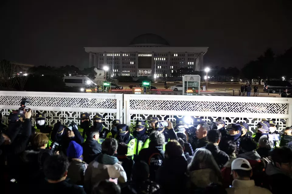 police officers stand guard at the gate of the national assembly after south korean president yoon suk yeol declared martial law in seoul south korea on december 4 2024 photo reuters police officers stand guard at the gate of the national assembly after south korean president yoon suk yeol declared martial law in seoul south korea on december 4 2024 photo reuters