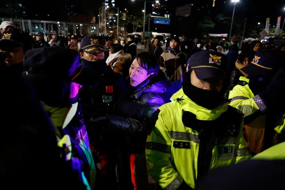 a man confronts police officers outside the national assembly after south korean president yoon suk yeol declared martial law in seoul south korea december 4 2024 photo reuters