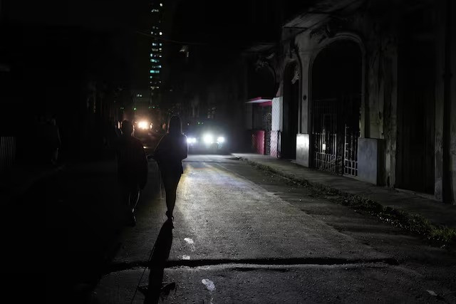 people walk on the street during an electrical grid collapse in havana cuba december 4 2024 photo reuters