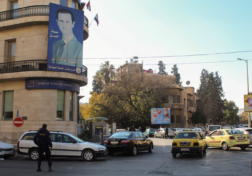 a poster depicting syria s president bashar al assad is placed on a building in damascus after last week s rebel seizure of aleppo marked the biggest offensive for years syria december 5 2024 photo reuters