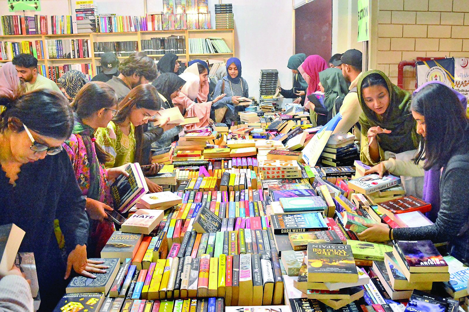 women browse through publications on display at the karachi international book fair which opened at expo centre on thursday photo jalal qureshi express