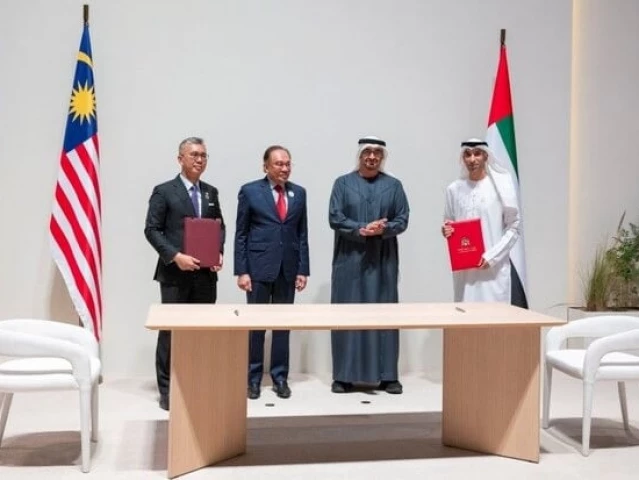 malaysian pm anwar ibrahim and uae president sheikh mohamed bin zayed al nahyan witness the signing of a comprehensive economic partnership agreement in abu dhabi on january 14 2025 courtesy wam malaysian pm anwar ibrahim and uae president sheikh mohamed bin zayed al nahyan witness the signing of a comprehensive economic partnership agreement in abu dhabi on january 14 2025 courtesy wam