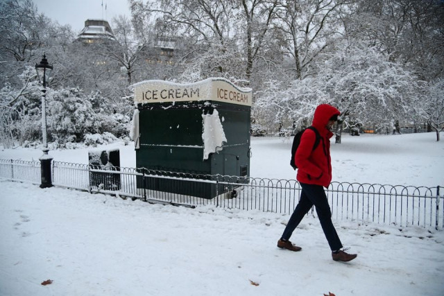 a person walks through the snow as cold weather continues in london britain december 12 2022 reuters a person walks through the snow as cold weather continues in london britain december 12 2022 reuters