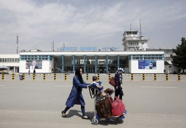afghan passengers walk in front of hamid karzai international airport in kabul afghanistan photo reuters afghan passengers walk in front of hamid karzai international airport in kabul afghanistan photo reuters