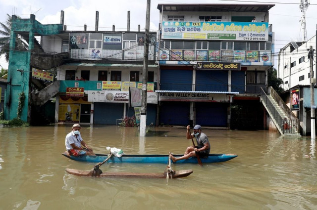 men float along a flooded road during a covid 19 curfew in biyagama near colombo sri lanka june 6 2021 photo reuters men float along a flooded road during a covid 19 curfew in biyagama near colombo sri lanka june 6 2021 photo reuters