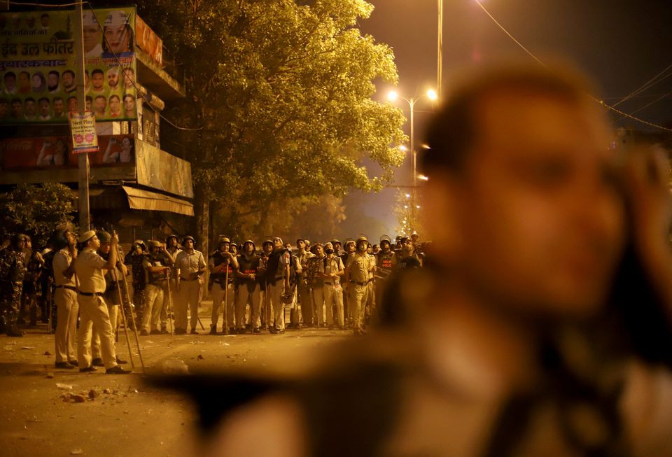 police personnel stand guard after clashes broke out during a hindu religious procession in jahangirpuri area of new delhi india april 16 2022 reuters
