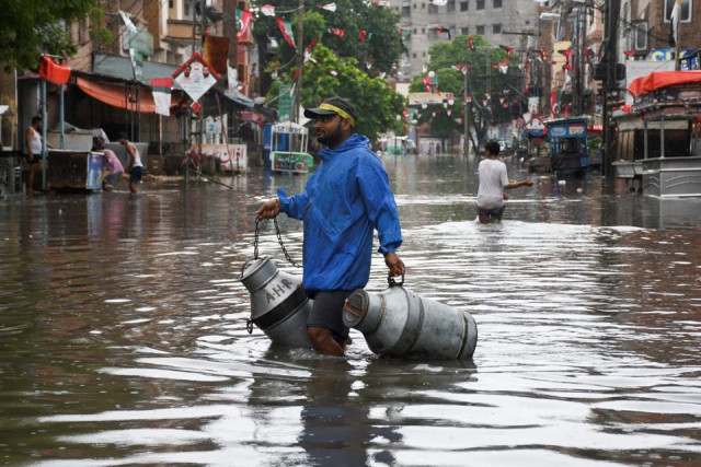 a man with milk canisters walks along a flooded street following rains during the monsoon season in hyderabad pakistan august 24 2022 reuters a man with milk canisters walks along a flooded street following rains during the monsoon season in hyderabad pakistan august 24 2022 reuters