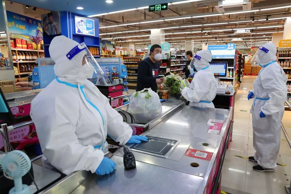 workers in protective suits attend to a customer at a checkout counter of a reopened supermarket amid the coronavirus disease covid 19 outbreak in shanghai china may 5 2022 picture taken may 5 2022 china daily via reuters workers in protective suits attend to a customer at a checkout counter of a reopened supermarket amid the coronavirus disease covid 19 outbreak in shanghai china may 5 2022 picture taken may 5 2022 china daily via reuters