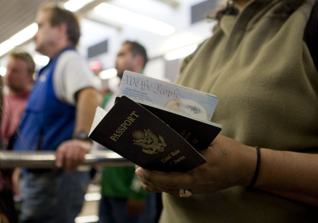 a woman holds passports while waiting to cross at the san ysidro border crossing in san ysidro california photo reuters a woman holds passports while waiting to cross at the san ysidro border crossing in san ysidro california photo reuters