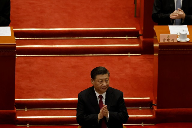 chinese president xi jinping applauds at the closing session of the chinese people s political consultative conference cppcc at the great hall of the people in beijing china march 10 2021 photo reuters