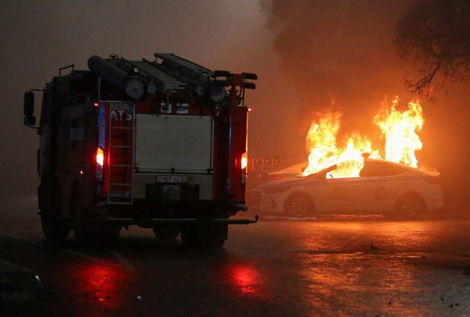 a view shows a burning police car during a protest against lpg cost rise following the kazakh authorities decision to lift price caps on liquefied petroleum gas in almaty kazakhstan january 5 2022 reuters