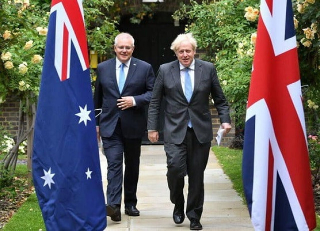 britain s prime minister boris johnson and australia s prime minister scott morrison walk in the garden of 10 downing street in london britain june 15 2021 photo reuters britain s prime minister boris johnson and australia s prime minister scott morrison walk in the garden of 10 downing street in london britain june 15 2021 photo reuters