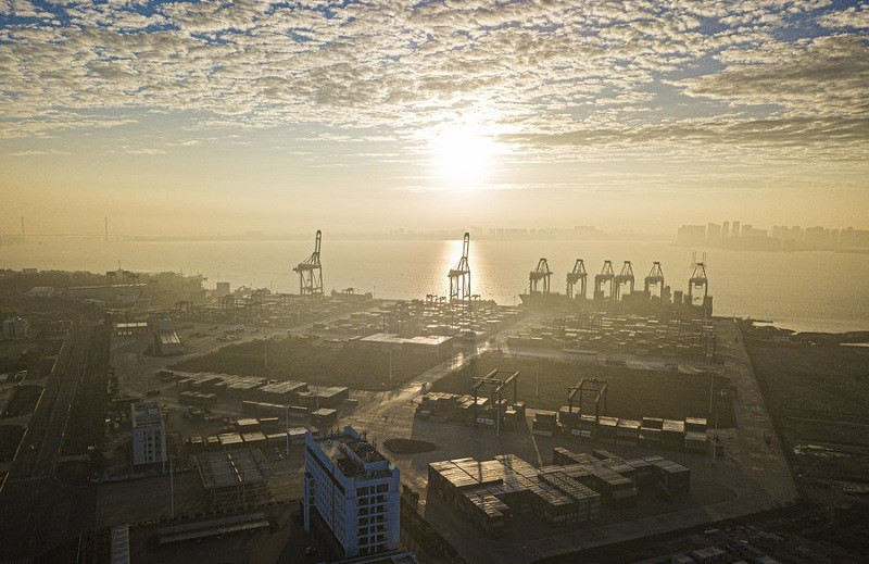 an aerial drone photo taken on jan 1 2024 shows the yangpu economic development zone at sunrise south china s hainan province photo xinhua