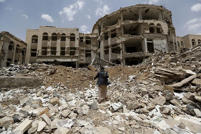 a houthi militant walks through a government compound following saudi led air strikes in the northwestern city of amran in july 2015 photo reuters a houthi militant walks through a government compound following saudi led air strikes in the northwestern city of amran in july 2015 photo reuters