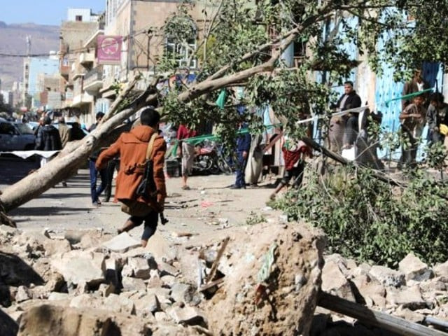 an armed man walks at the site of a saudi led air strike in sanaa yemen credit photo reuters an armed man walks at the site of a saudi led air strike in sanaa yemen credit photo reuters