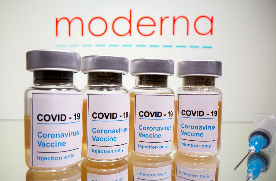 vials with a sticker reading covid 19 coronavirus vaccine injection only and a medical syringe are seen in front of a displayed moderna logo in this illustration taken october 31 2020 photo reuters