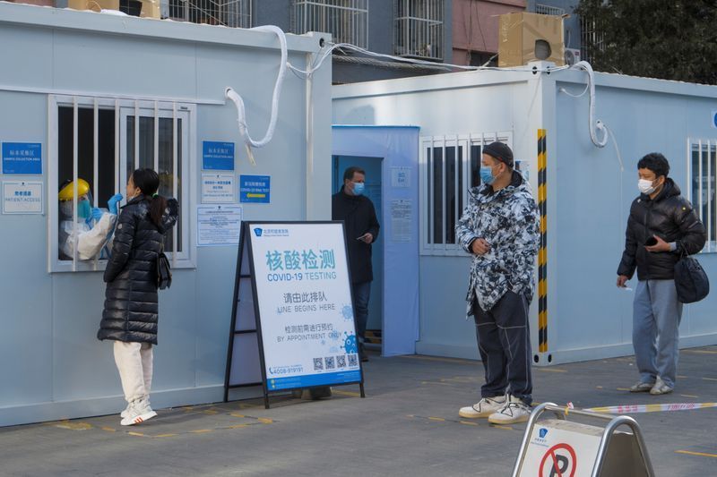 people line up to get their nucleic acid test in the courtyard of a hospital following the outbreak of the coronavirus disease covid 19 in beijing china january 13 2021 reuters
