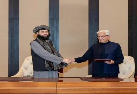 defence minister khawaja muhammad asif and afghan defence minister mullah mohammad yaqoob mujahid shake hands following the signing of a ceasefire agreement mediated by qatar and turkey in doha on october 19 photo reuters