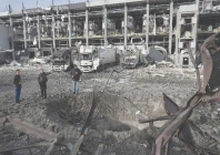 law enforcement officers inspect a crater next to the heavily damaged logistics hub of the novus supermarket following russian missiles and drones strikes in kyiv photo afp