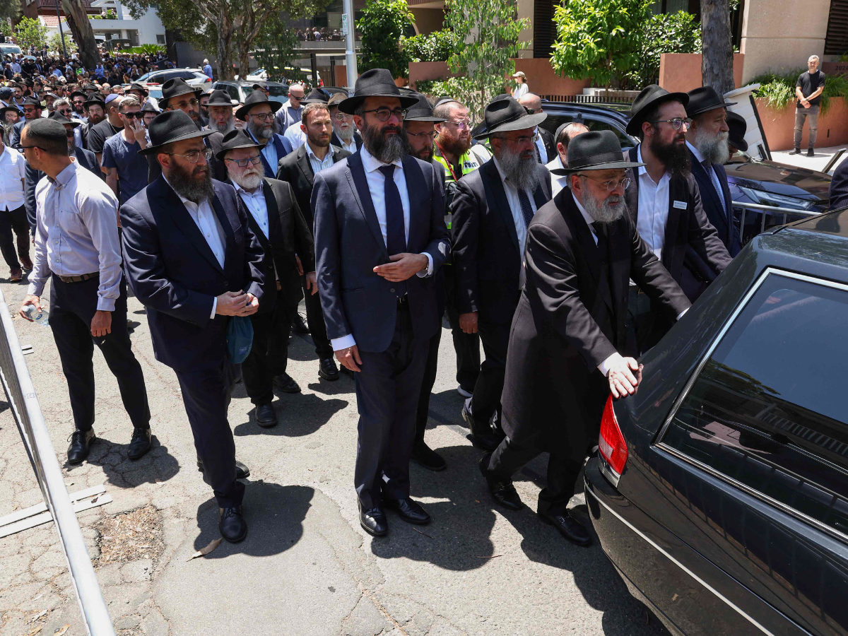 Mourners follow the hearse carrying the coffin of rabbi Eli Schlanger, who was killed in the December 14 Bondi beach shooting attack, after his funeral service at the Chabad of Bondi Synagogue in Sydney on December 17, 2025. Photo: AFP