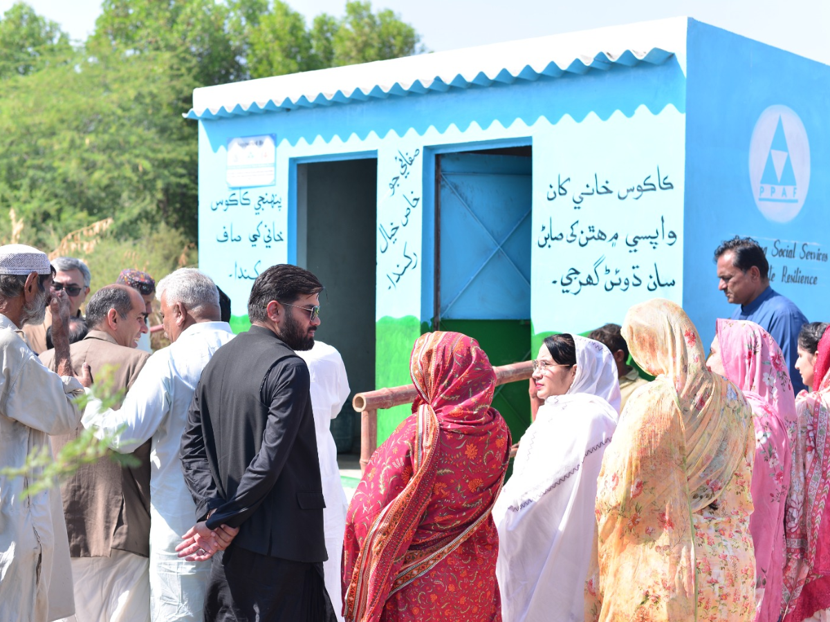 A toilet facility developed in Union Councils Garho and Bijoro, District Thatta, featuring a message in Sindhi on the wall that highlights the importance of sanitation and encourages handwashing. Photo by Author