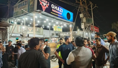 police and authorities are standing outside a restaurant during a crackdown launched against roadside encroachment in karachi photo handout
