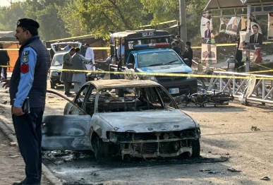 policemen examine damaged vehicles after a suicide blast outside the district court in islamabad on november 11 2025 photo afp
