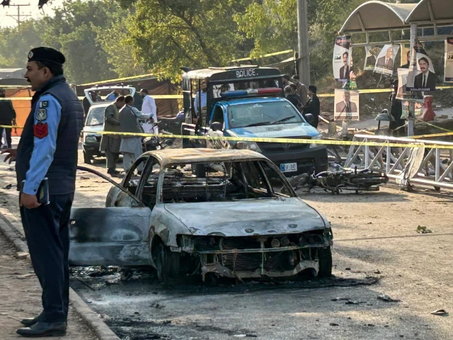 policemen examine damaged vehicles after a suicide blast outside the district court in islamabad on november 11 2025 photo afp