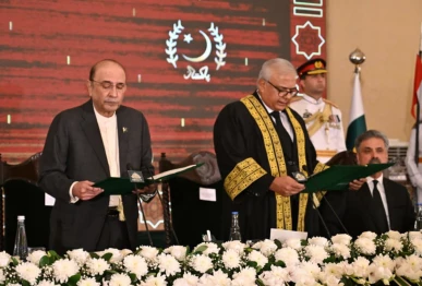 president asif ali zardari administers the oath to justice aminuddin khan as chief justice of the federal constitutional court during a ceremony at aiwan i sadr on friday photo app