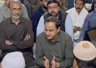 karachi mayor murtaza wahab speaks with relatives of three year old ibrahim who fell into a manhole in karachi during a visit to the boy s home photo express