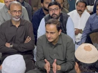 karachi mayor murtaza wahab speaks with relatives of three year old ibrahim who fell into a manhole in karachi during a visit to the boy s home photo express