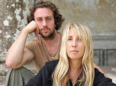 aaron taylor johnson 33 and director wife sam 57 pose together on back to black red carpet aaron taylor johnson 33 and director wife sam 57 pose together on back to black red carpet