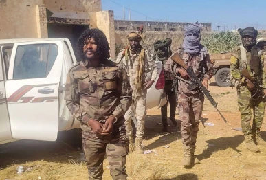 this handout picture released by the sudanese rapid support forces rsf on october 30 2025 shows rsf members reportedly detaining a fighter known as abu lulu l in el fasher in war torn sudan s western darfur region    rapid support forces rsf afp