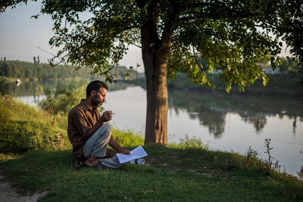 ghulam mohammad bhat who writes under the pen name madhosh balhami reads and composes poetry in secret in kashmir sometimes by the banks of the jhelum river photo the new york times