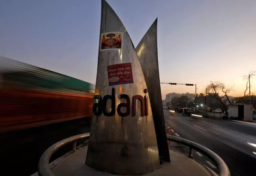 traffic moves past the logo of the adani group installed at a roundabout on the ring road in ahmedabad india feb 2 2023 reuters amit dave file photo traffic moves past the logo of the adani group installed at a roundabout on the ring road in ahmedabad india feb 2 2023 reuters amit dave file photo