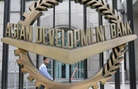 a worker walks past inside the asian development bank adb headquarters in manila june 17 2009 reuters