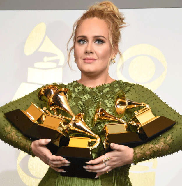 adele poses in the press room with her trophies photo afp