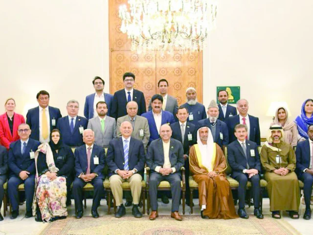president asif ali zardari smiles for a group photo at the conclusion of an international conference in islamabad photo express