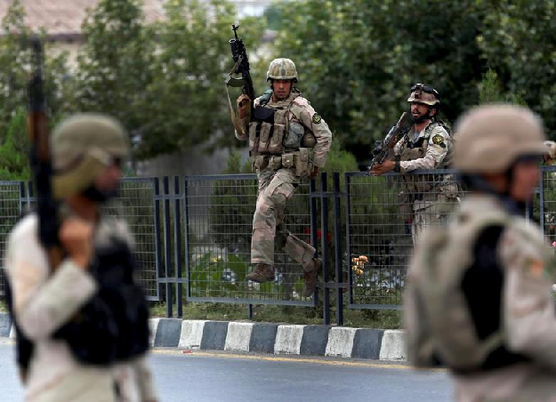 Members of Afghan security forces climb over a fence in Kabul, Afghanistan. PHOTO: Reuters
