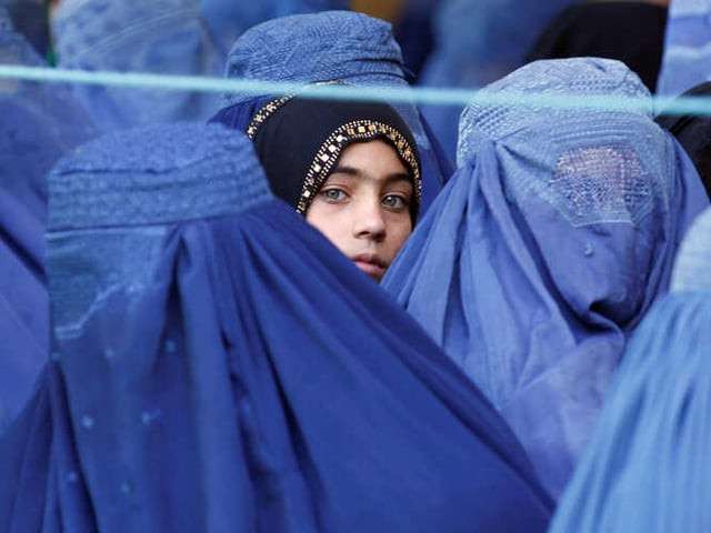a girl looks on among afghan women lining up to receive relief assistance in jalalabad afghanistan june 11 2017 photo reuters a girl looks on among afghan women lining up to receive relief assistance in jalalabad afghanistan june 11 2017 photo reuters