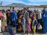 afghan refugees wait in a queue to cross the pakistan afghanistan border in torkham on october 27 2023 photo afp