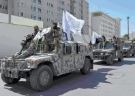 victory celebrations a convoy of taliban security personnel take part in a parade in front of the former us embassy building in kabul photo afp