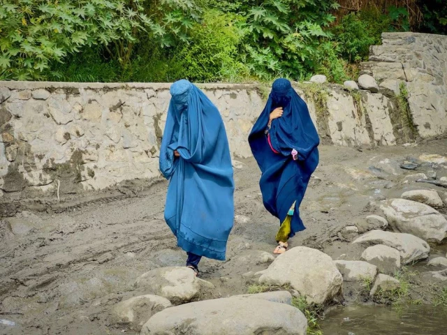 afghan women in burqas walk towards a safer place after their house was damaged following a deadly magnitude 6 earthquake that struck afghanistan on sunday at lulam village in nurgal district kunar province afghanistan september 3 photo reuters