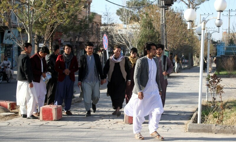 male students arrive at the herat university after the universities were reopened in herat on march 6 2023 photo afp